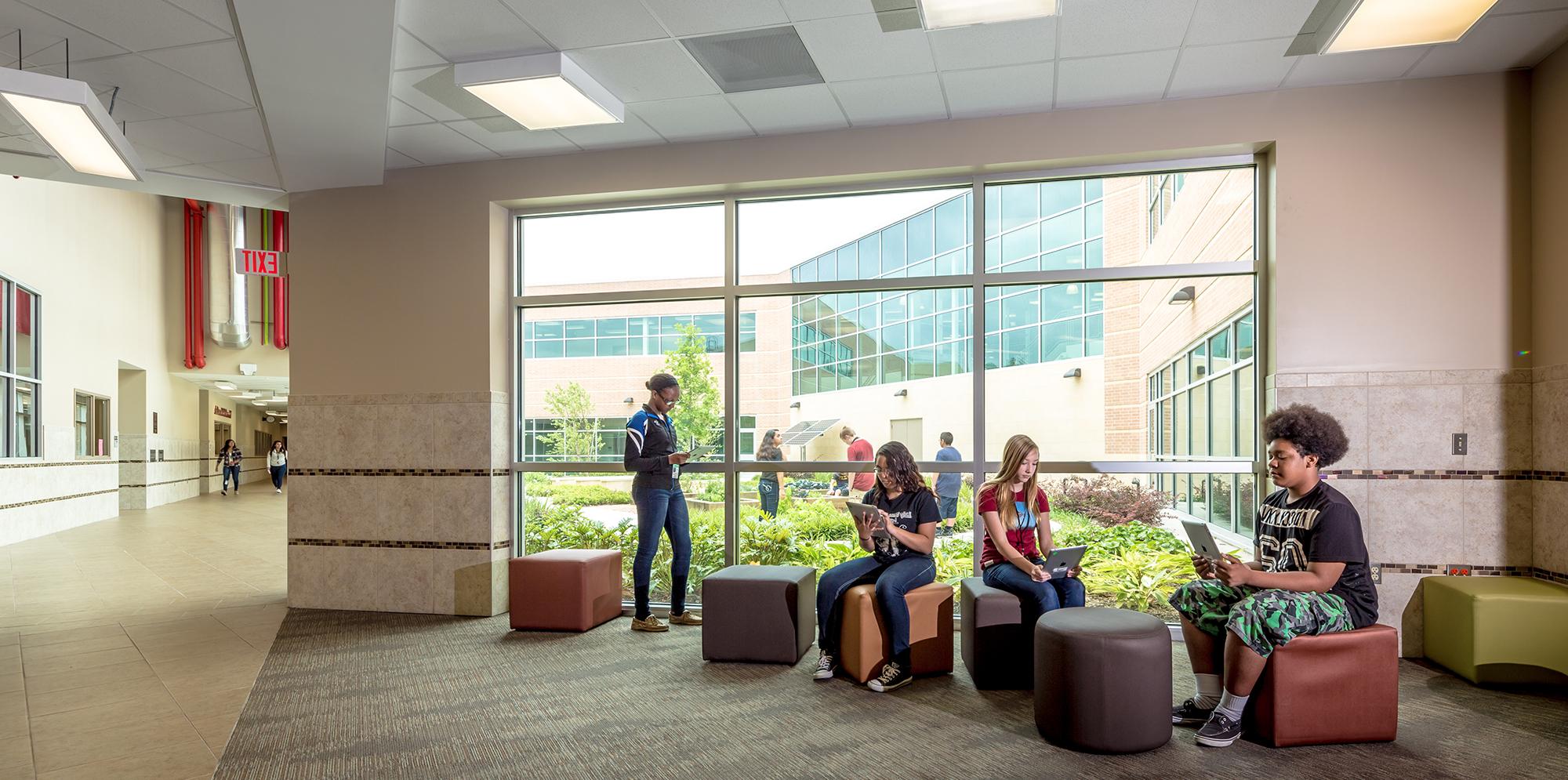 Seating area with cube and cylinder shaped seats inside William R. Blocker Middle School, planned by IBI Group